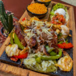 fajita platter of meat with veggies on a platter from Cabrera's