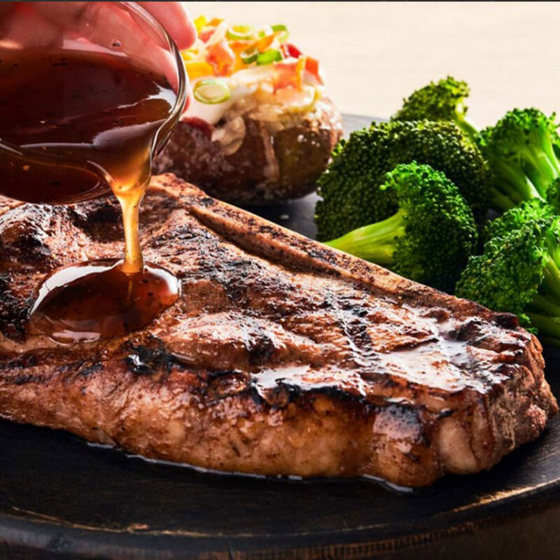 Bourbon Glazed Bone-In New York Steak with hand pour sauce on steak from Outback Steakhouse