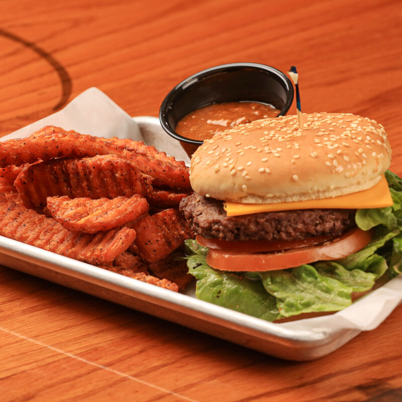cheese burger on a platter with fries from Clearman's Galley