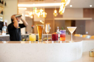 a line of cocktails on a bar top at 1913 Restaurant